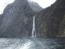 A waterfall cascades into the glacier-carved fiord at Milford.